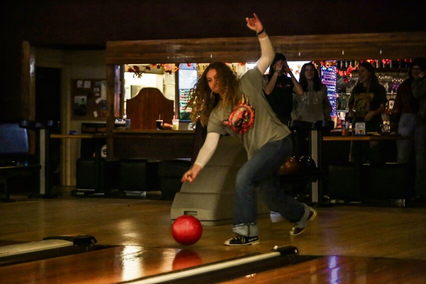 Emma Faw aims for a strike at Yelm High School bowling practice at Prairie Lanes on Nov. 13.