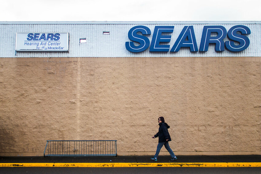 A woman walks in front of Sears shopping center in Chehalis in this 2018 Chronicle file photo.