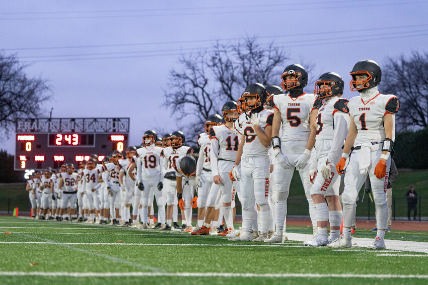 Napavine players stand for the National Anthem ahead of the Tigers&rsquo; 23-8 2B State Semifinal win over Asotin at Fran Rish Stadium in Richland on Saturday, Nov. 30.