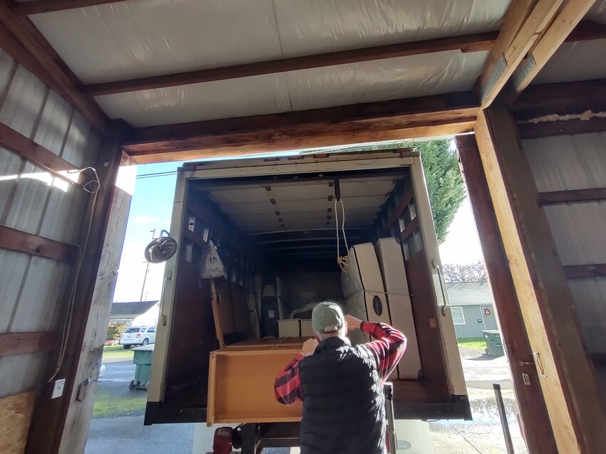 A Love INC volunteer loads furniture into a truck to donate to a client in this photo provided by the nonprofit. This year alone, the nonprofit has assisted 400 families, providing everything from eyeglasses and furniture to a wheelchair ramp and rental assistance.