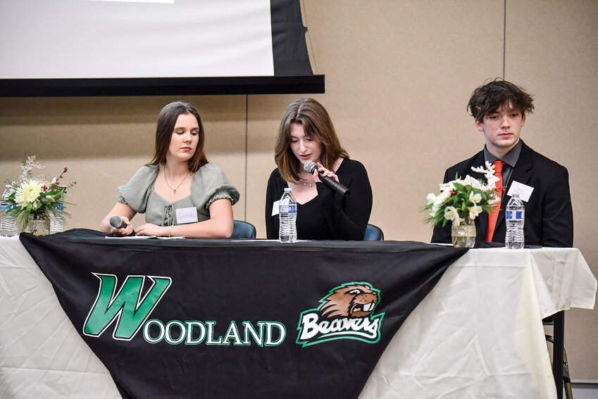 Woodland High School students Savannah Doughty (left), Sam Brown and Gavin Shoemaker ask questions they prepared to three panelists during their first &ldquo;Civic Power Hour.&rdquo; The Wednesday, Dec. 11, event was hosted, planned and advertised by 31 students from Shari Conditt&rsquo;s advanced placement government class.