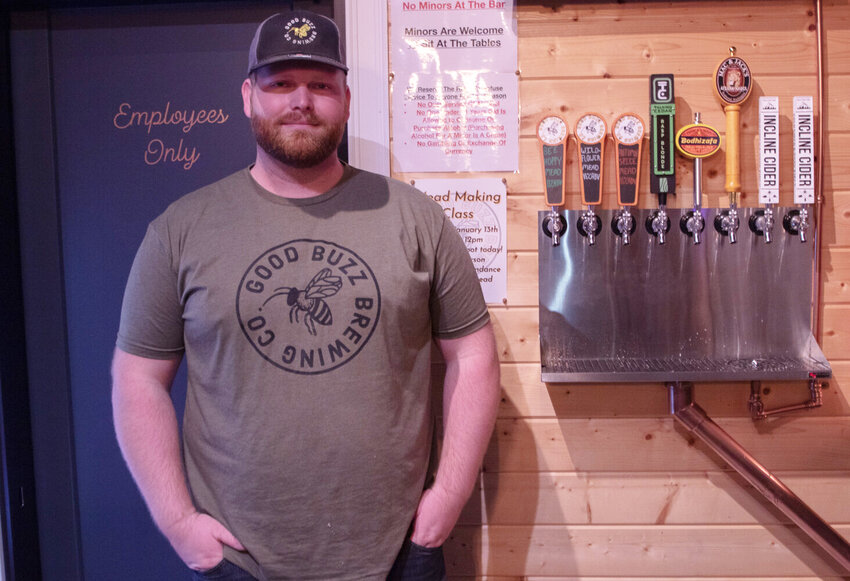 Good Buzz Brewing Co. co-owner Forrest Chesvick poses for a photo behind the bar of his taproom, located at 1640 S. Gold St. in Centralia, on Friday, Dec. 29, 2023.