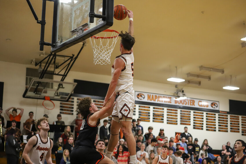 Napavine's Karsen Denault attempts to dunk over Rainier's Jordan Pringle on Dec. 18.