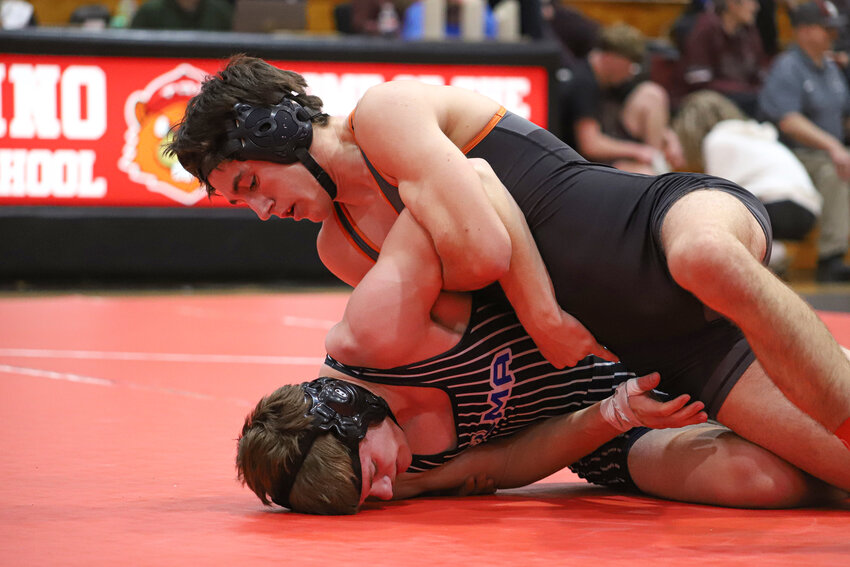 Zander Peck of Rainier pins down Lucky Douvier of Elma in the 165-pound finals at the Stonetown Throwdown at Tenino High School on Dec. 21.