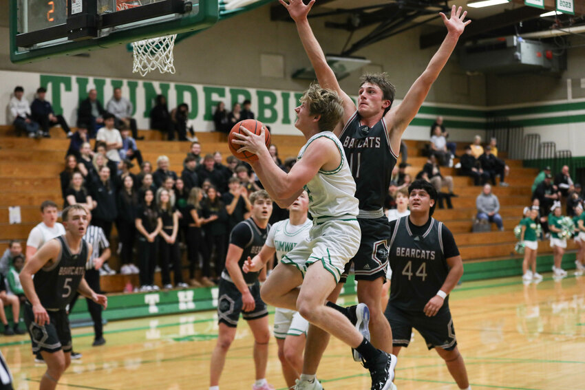 Tumwater's Luke Overbay attempts a layup around a defender during Tumwater's win over W.F. West on Jan. 8.