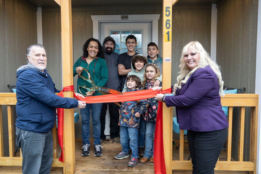 From the left, Chehalis Mayor Tony Ketchum, Critter Care Owner Brittany Toepelt, Tim Toepelt, Liam, Logan, Caden, Khaleesi and Declan Toepelt and Christine Brower pose for a photo during a ribbon-cutting for Chehalis Critter Care hosted by The Centralia-Chehalis Chamber of Commerce on Friday, Jan. 17. The grooming service is located at 561 U.S. Hwy 12.