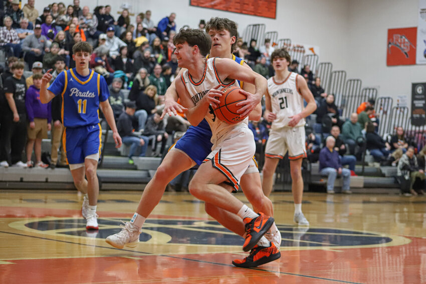 Rainier's Josh Meldrum scoots past Adna's Beau Miller on Jan. 22.