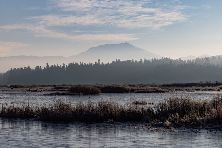 Haze and fog cover Mount St. Helens as seen from Silver Lake on Thursday, Jan. 23.