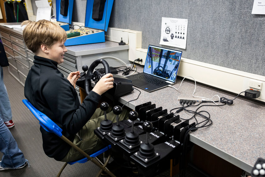 Easten Lund, an eighth grader at Chehalis Middle School, operates a forklift simulator in Centralia College&rsquo;s careers and technical education mobile classroom at Chehalis Middle School on Tuesday, Jan. 28. The mobile classroom stays parked at the school through the month for a hands on learning experience on how to operate trades equipment.