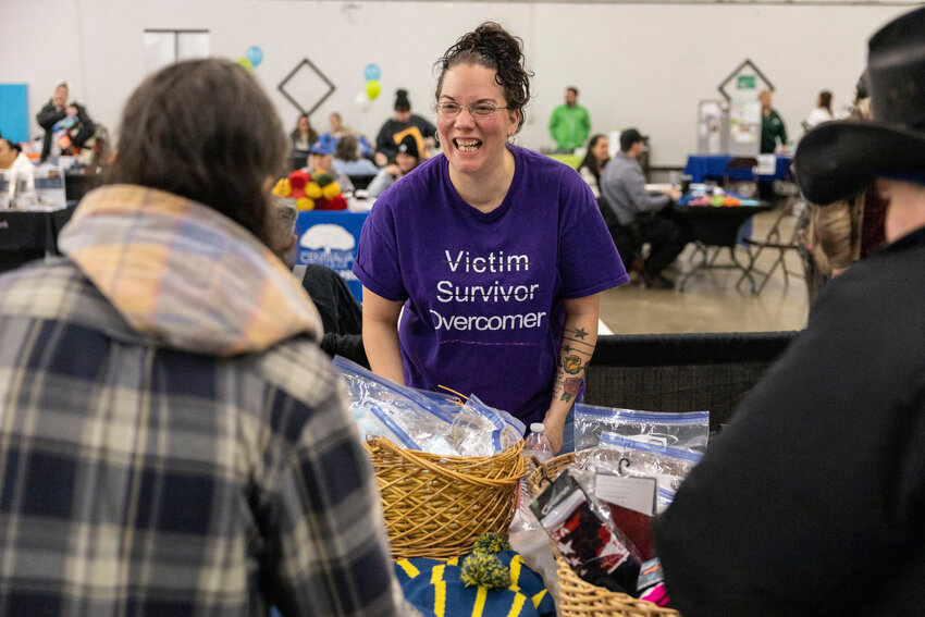 Brandi Meyer, a domestic violence and sexual assault advocate for Hope Alliance, speaks to attendees during a Homeless Connect event in the Blue Pavilion at the Southwest Washington Fairgrounds on Friday, Jan. 31.