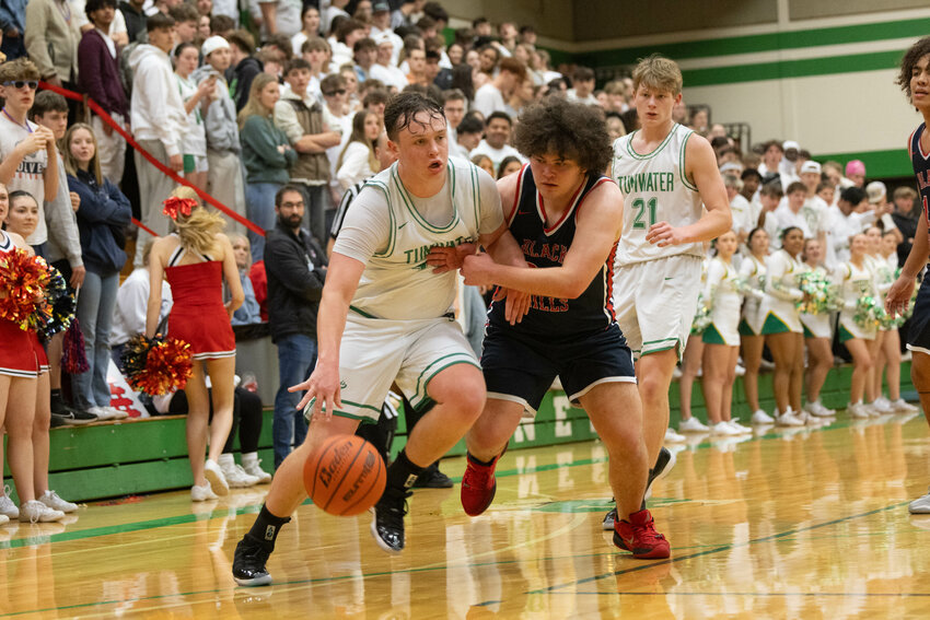 Tumwater's Jake Dillon attempts to drive inside during Tumwater's win over Black Hills on Jan. 31.