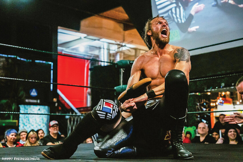 Brian Cook wrestles as &quot;Evil Brian&quot; against Drake Kwon in Portland.
