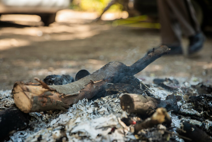 FILE PHOTO &ndash; Smoke smolders in a fire pit at a homeless encampment at the end of Eckerson Road in Centralia in 2022.