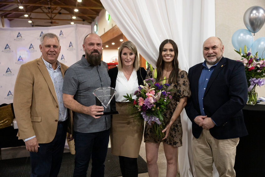 Samantha and Spike Magnuson and Angie Twining of Lewis County Coffee Company pose for a photo after being honored with the Community Commitment Award during the Economic Alliance of Lewis County&rsquo;s annual banquet at Jester&rsquo;s Auto Museum in Chehalis on Friday, Feb. 7. They're pictured with Executive Director Richard DeBolt, far left, and Program Manager Todd Chaput