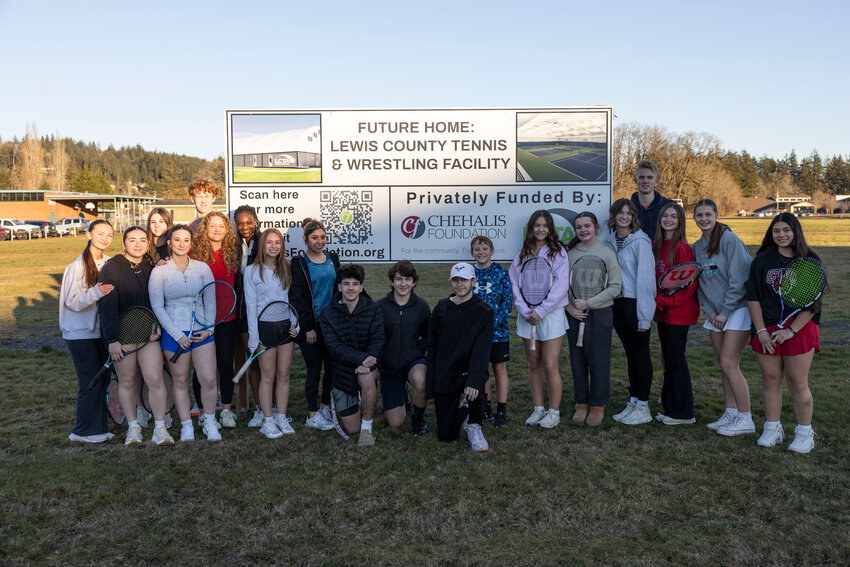 Centralia and W.F. West high school and middle school students pose for a photo on the site of the  future Lewis County tennis and wrestling indoor facility off of Bishop Road in Chehalis on Tuesday, Feb. 11.