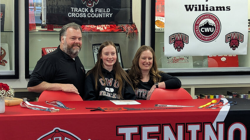 Tenino's Brynn Williams poses with her parents, Brock and Heidi, after signing her National Letter of Intent to run track and cross country at Central Washington University during a signing ceremony at Tenino High School on Feb. 13.