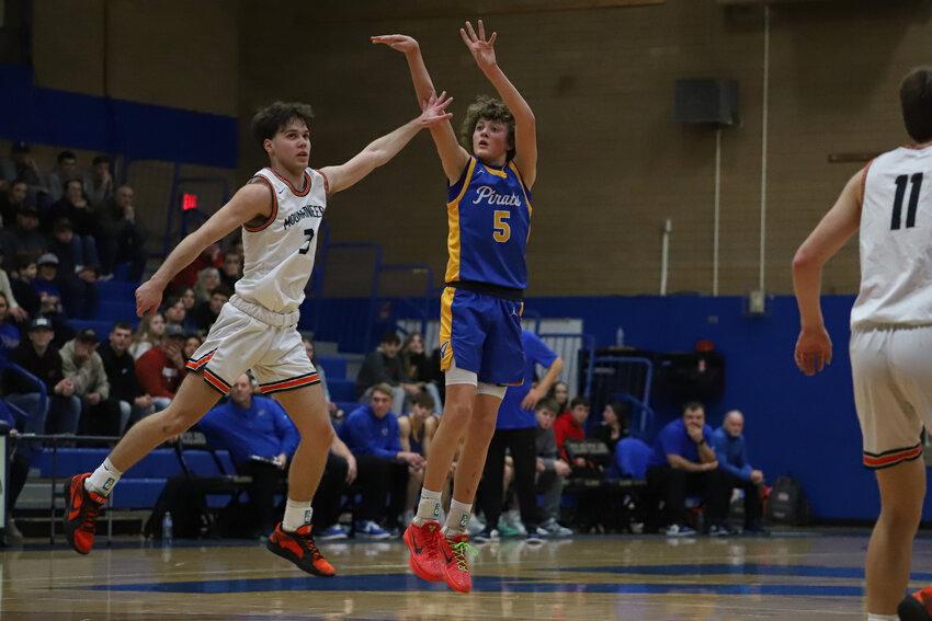 Adna's Trevin Salme shoots a deep 3-pointer over Rainier's Josh Meldrum in the 2B District 4 semifinals at Kelso High School on Feb. 19.