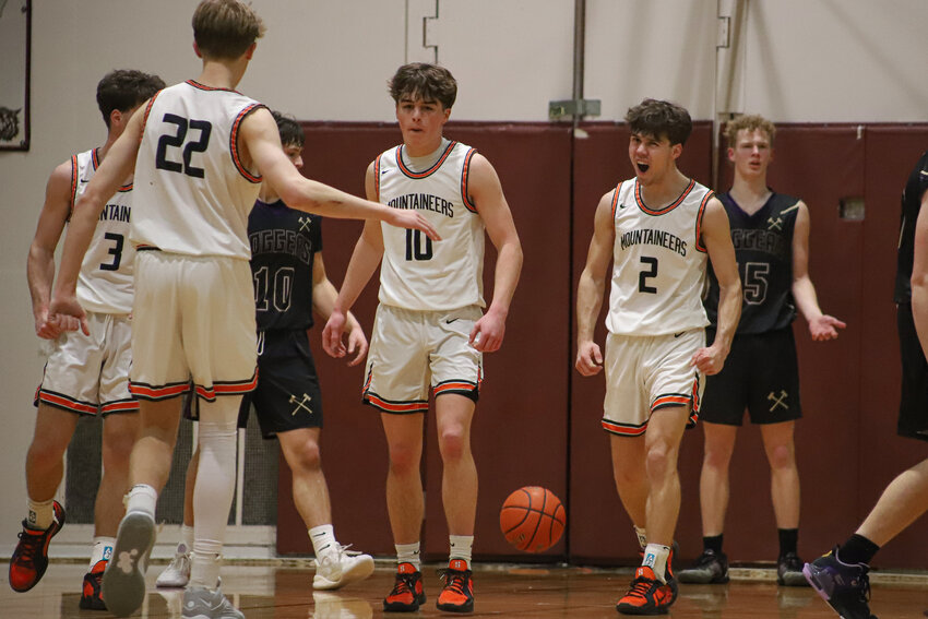 Rainier celebrates as Jordan Pringle, 10, makes an and-one layup against Onalaska in a 2B District 4 elimination game at W.F. West High School on Feb. 21.