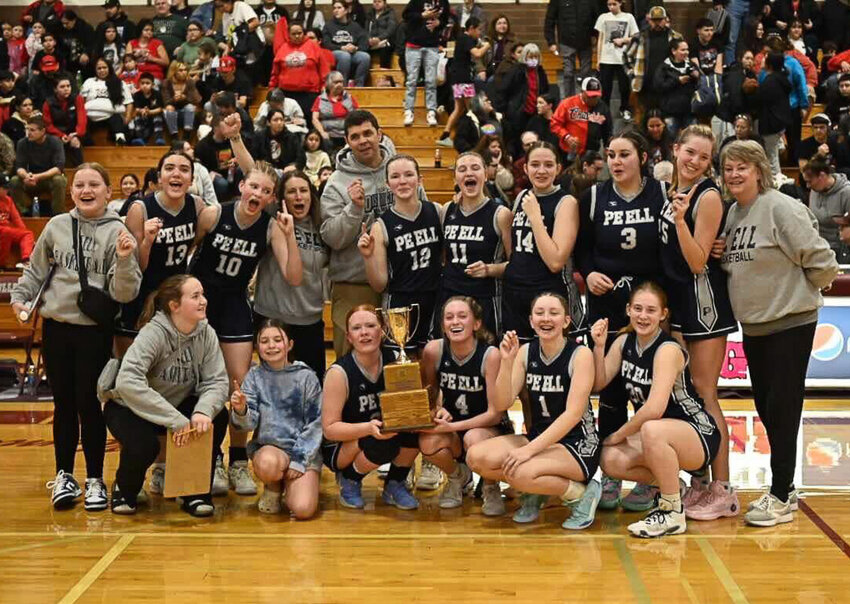The Pe Ell girls basketball team poses with the 1B District 4 trophy after winning the district championship game over Taholah in Montesano on Feb. 22.