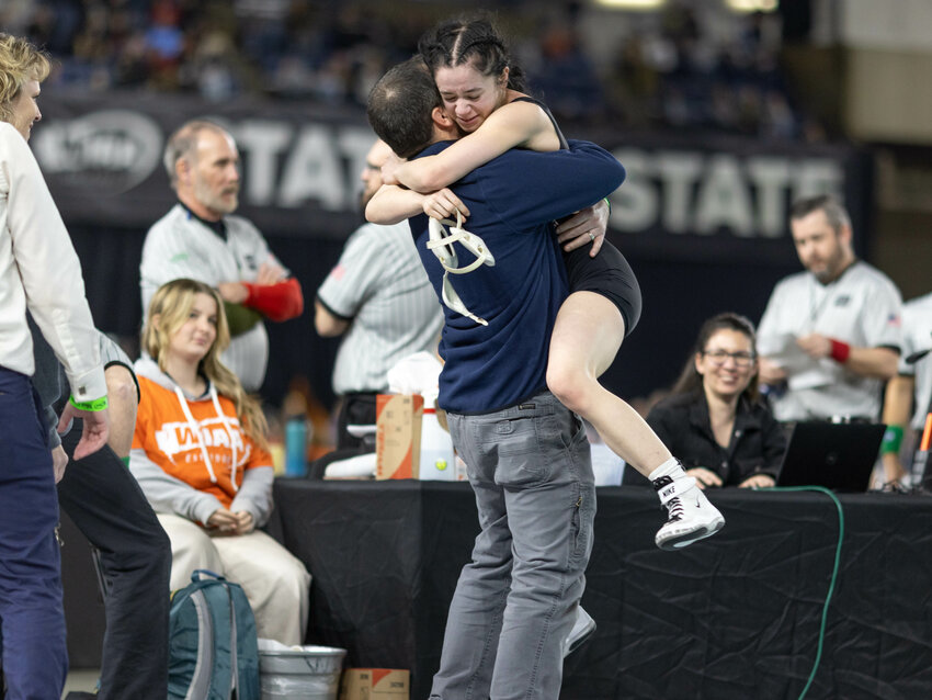 Black Hills' Sloane Kruger leaps into the arms of her coach and dad Stephen Kruger after winning the Class 2A 100-pound state title at Mat Classic XXXVI on Saturday, Feb. 22 inside the Tacoma Dome.