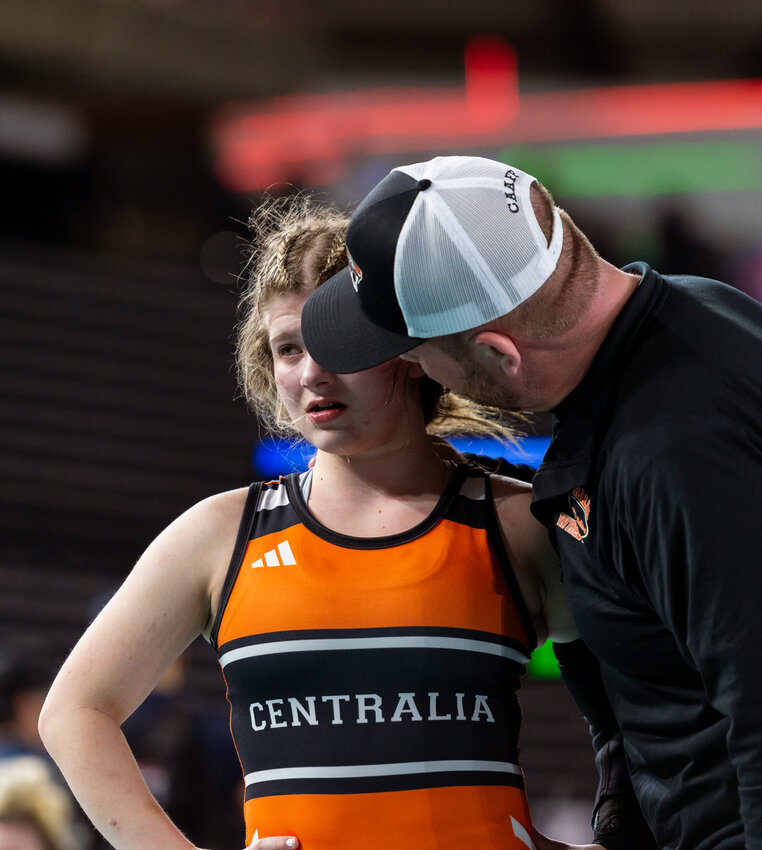 A coach talks with Centralia&rsquo;s Ramona Reinitz after her injury time ran out in the 2A Girls 120-pound semifinal at Mat Classic XXXVI on Saturday, Feb. 22, at the Tacoma Dome. (Joshua Hart/For The Chronicle)