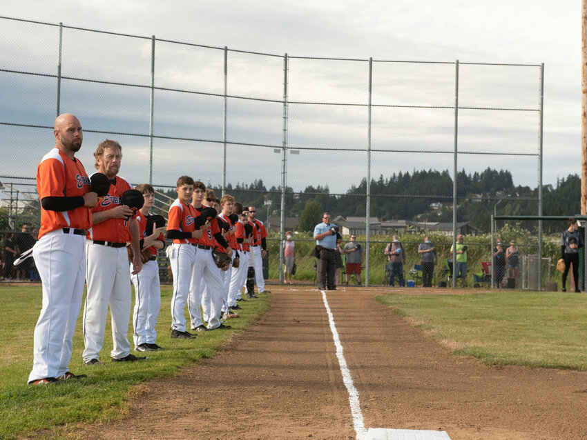 Eubanks Babe Ruth team (orange) lines up for the national anthem on opening day in June 2020 at Stan Hedwall Park in Chehalis.