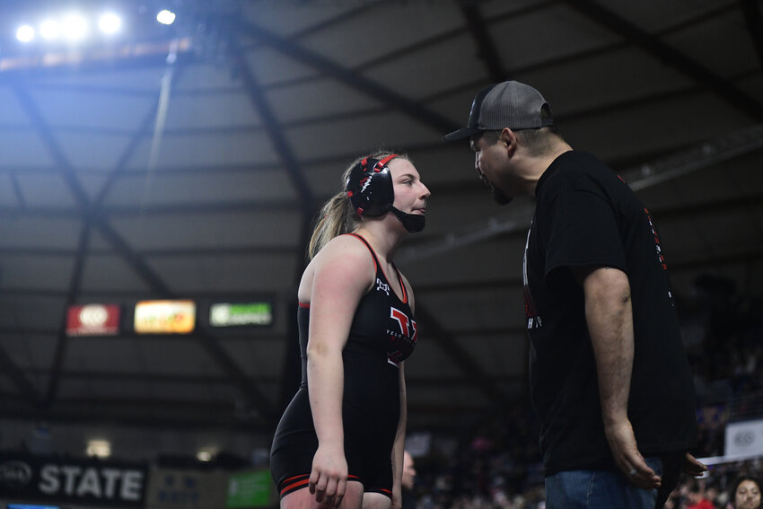 Yelm girls wrestling head coach Ben Hawk motivates Mariah Gibson, 155 pounds, on Thursday, Feb. 20, at WIAA's Mat Classic XXXVI inside the Tacoma Dome.