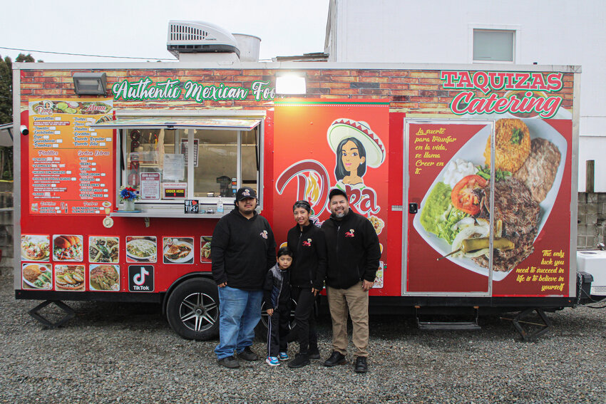 America Arellano and Amador Rodriguez, right, pose with their children, left, in front of DARA Mexican Food in Rainier on Feb. 24.