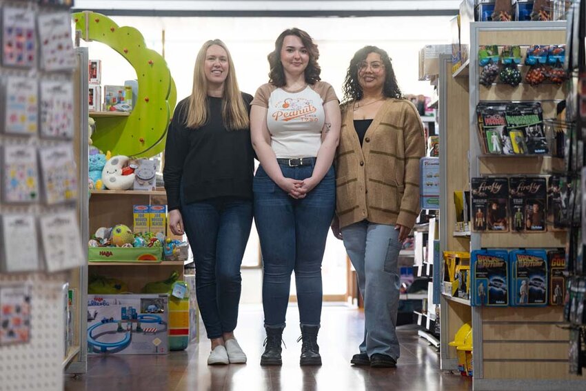 Co-owners Danielle Esquibel, left, and Priscilla Rojas, right pose for a photo with employee Briar Rose at Let&rsquo;s Play Something in downtown Centralia on Tuesday, Feb. 25.