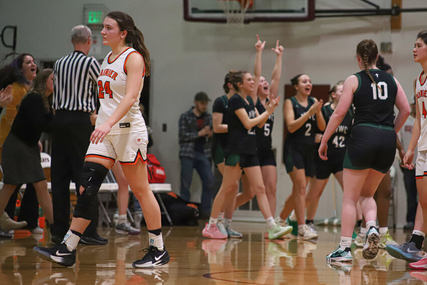 Bryn Beckman walks off the floor as Northwest Christian (Colbert) celebrates its 53-42 upset victory in the 2B state tournament opening round at W.F. West High School on Feb. 28.