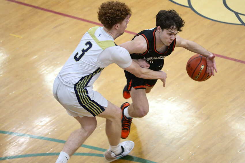 Rainier's Jacob Meldrum (dribbling) loses control of the ball while guarded by Tri-Cities Prep's Bryson Wilde in a Class 2B State Tournament Opening Round game on Saturday, March 1 at Richland High School.