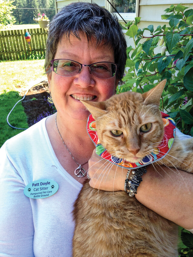 Patt Doyle, owner of Pampurred Pet Care, holds Ginger, an orange tabby, in her arms. Doyle will host Coffee Caturday, a new local event, from 10 a.m. to 3 p.m. on Saturday, March 8, at the Battle Ground Event Center.
