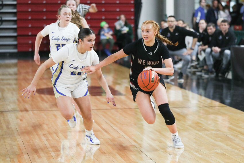 W.F. West's Dilyn Boeck drives past a defender during W.F. West's loss to Deer Park in a 2A State Tournament Quarterfinal at the Yakima SunDome on March 6.