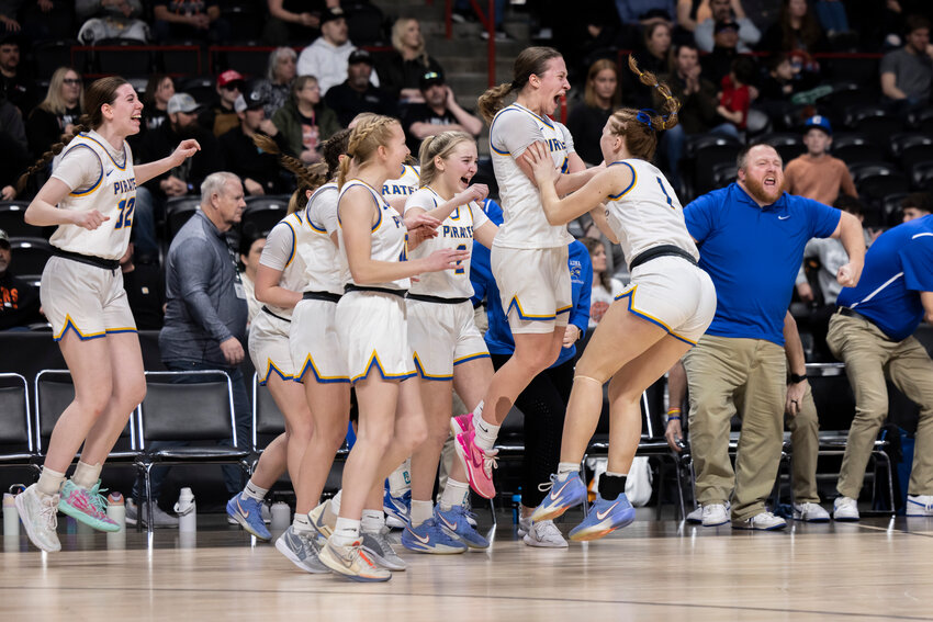 Adna players celebrate winning the 2B Girls State Tournament Semifinal game against Napavine at the Spokane Arena on Friday, March 7.
