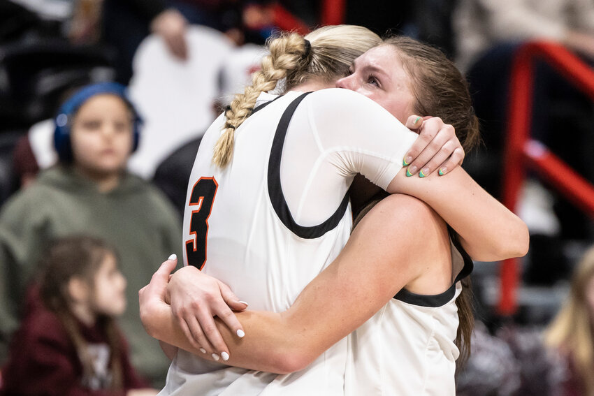 Napavine's Hayden Kaut (3) and Napavine's Jessie McCoy (10) embrace as McCoy walks off the court for the final time after winning the 2B Girls State Tournament Third Place game against Reardan at the Spokane Arena on Saturday, March 8.