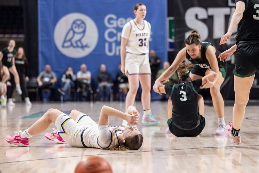 Adna&rsquo;s Karsyn Freeman (4) lays on the court after fouling out in overtime during the 2B Girls State Championship game against Northwest Christian at the Spokane Arena on Saturday, March 8.