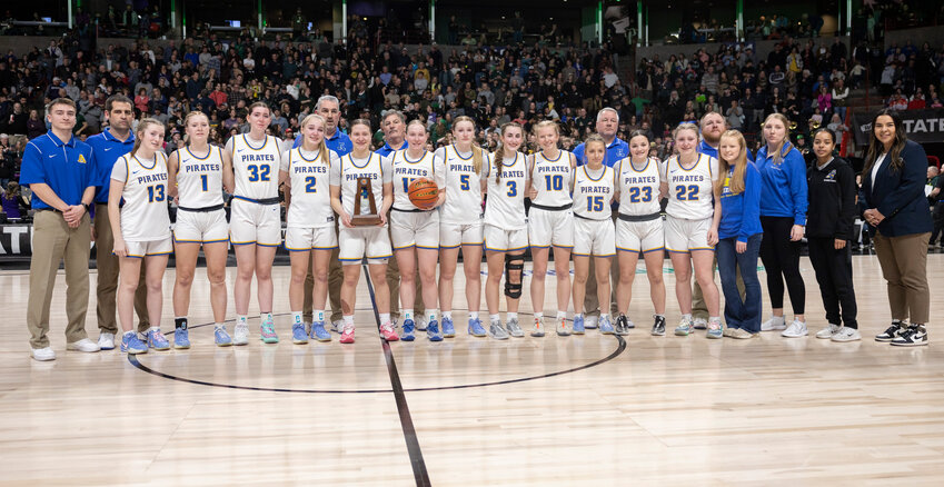 Adna players and coaches pose with the second place trophy after the 2B Girls State Championship game against Northwest Christian at the Spokane Arena on Saturday, March 8.