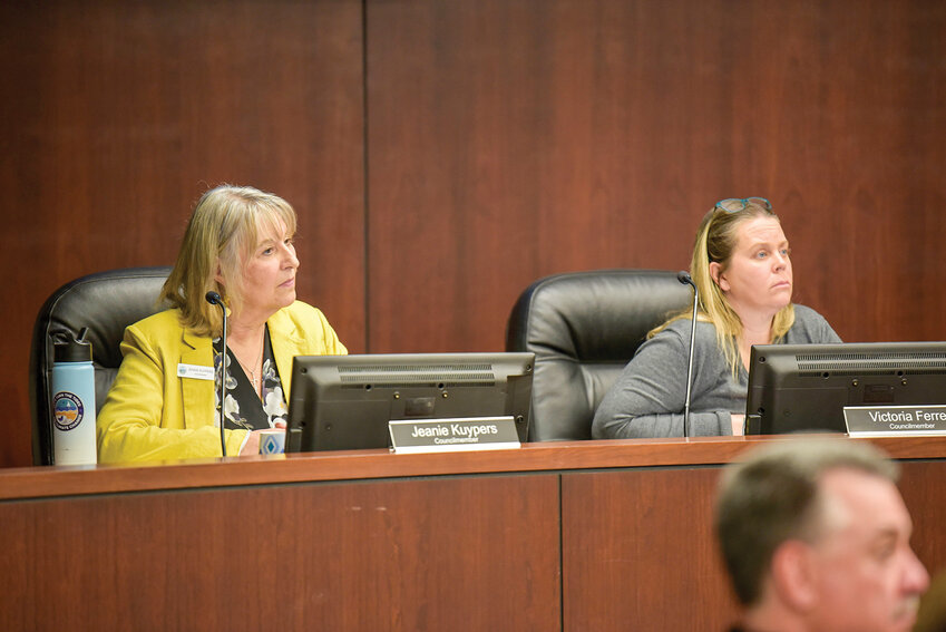 Councilmembers Jeanie Kuypers, left, and Victoria Ferrer listen to residents' concerns regarding the implementation of light rail for the Interstate Bridge Replacement Project during a March 3 meeting. Both voted in favor of the resolution opposing light rail, which passed 4-3.