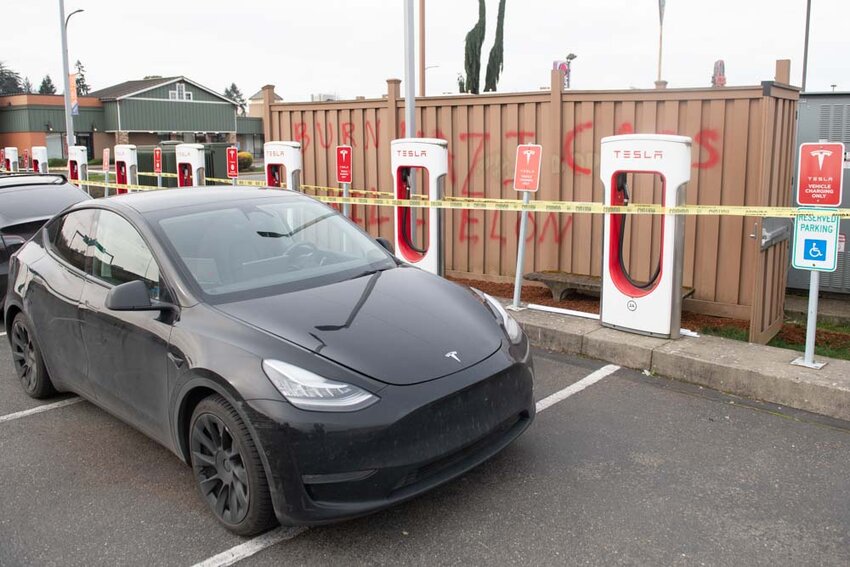 Vandalism spray painted on the Lum Road Tesla Supercharge Station is pictured in Centralia on Tuesday, March. 11.
