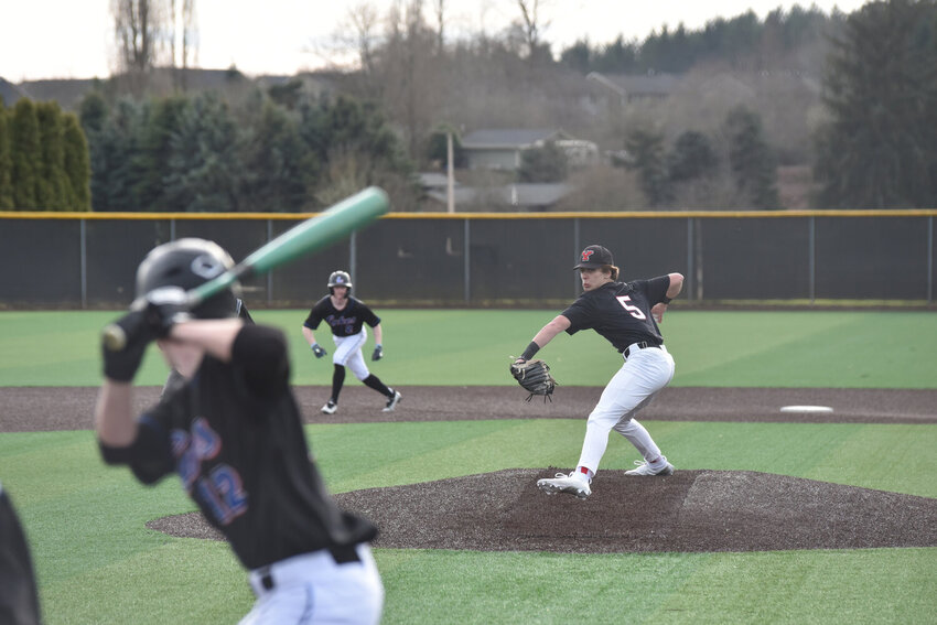 Yelm RHP Wyatt Robison winds up to deliver a pitch against the Lakes Lancers on Friday, March 8, 2024,  in the team's home opener.