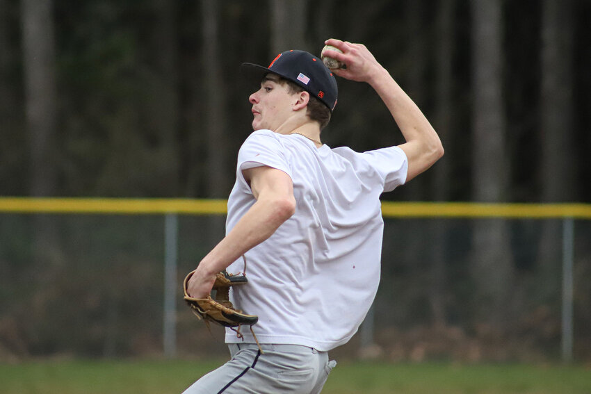Hunter Howell winds up to pitch during Rainier Mountaineers baseball practice on March 10.