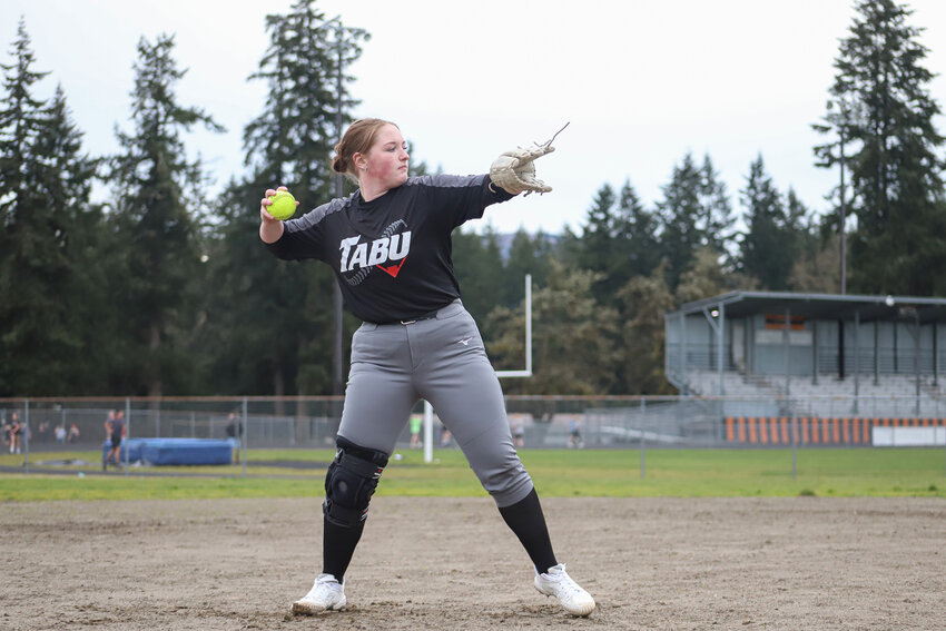 Ryleigh Cruse warms up her arm during Rainier Mountaineers fastpitch practice on March 10.