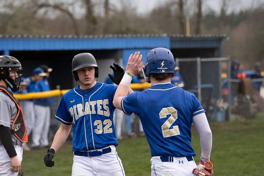 Adna's Bryce Pine (32) high-fives Luke Mohney (2) during Adna's win over Morton-White Pass on March 14.