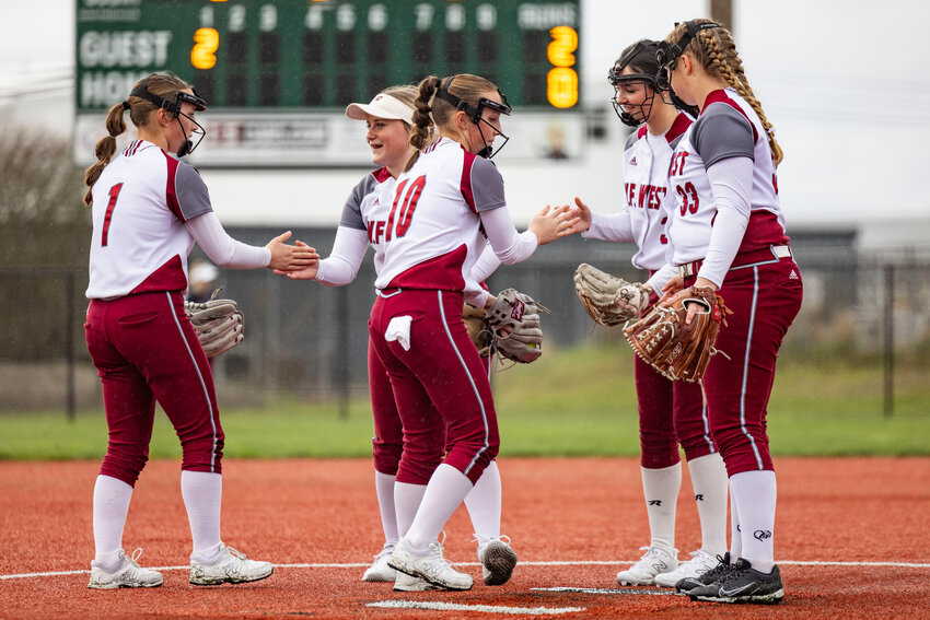 W.F. West players shake hands between plays of a softball game against Camas at Recreation Park in Chehalis on Friday, March 14.