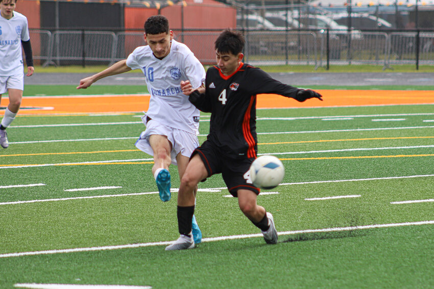 Centralia's Johnny Ruiz (4) fends off a Mark Morris defender at Centralia High School on Saturday, March 15.