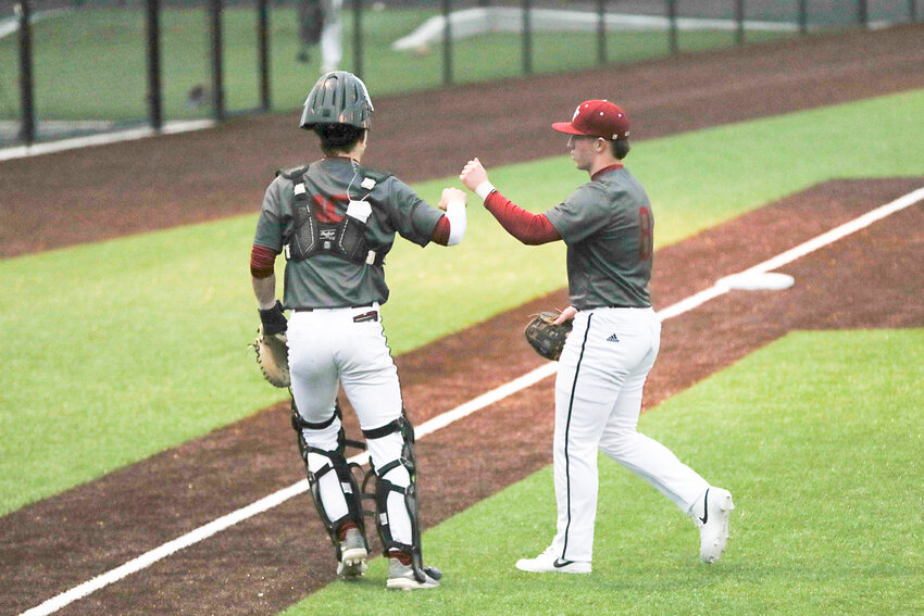 W.F. West's Miles Martin fist-bumps his catcher while walking off the field at the end of an inning during a scrimmage against Rochester at W.F. West on March 11.