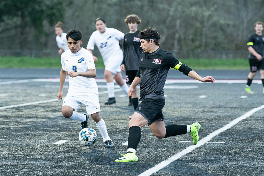 Tenino's Miguel Espinoza dribbles around a defender during Tenino's win over Chief Leschi on March 18.