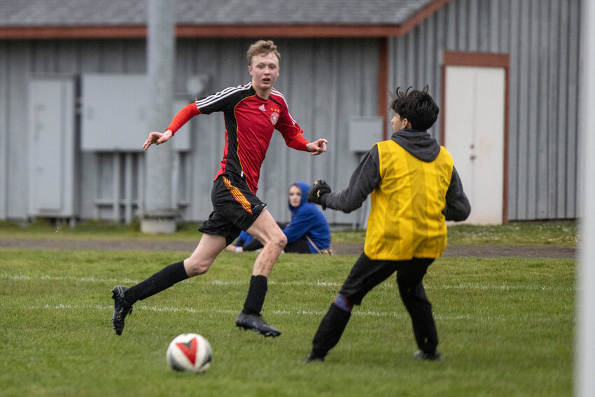 Toledo/Winlock United's Christoph Danger (10) kicks the ball past Onalaska&rsquo;s goalie to score during a soccer game at Toledo High School on Wednesday, March 19.
