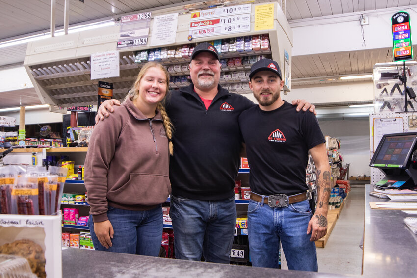 D9 Country Market owner Kyle Deskins, center, poses with his son, Kody Deskins, and niece, Carlie Deskins, on Friday, March 21, inside the family's new business on U.S. Highway 12 in Ethel.