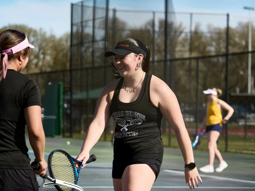 Centralia's Suki Bringman high-fives a teammate with her racket during Centralia's win over Aberdeen on March 25.